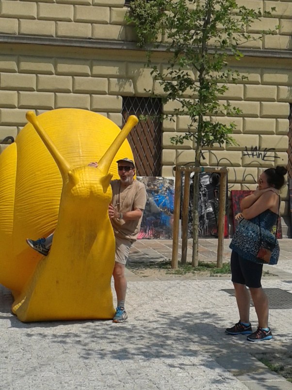 The bushsnob attempting to board the snail under the amused watch of the Ed.